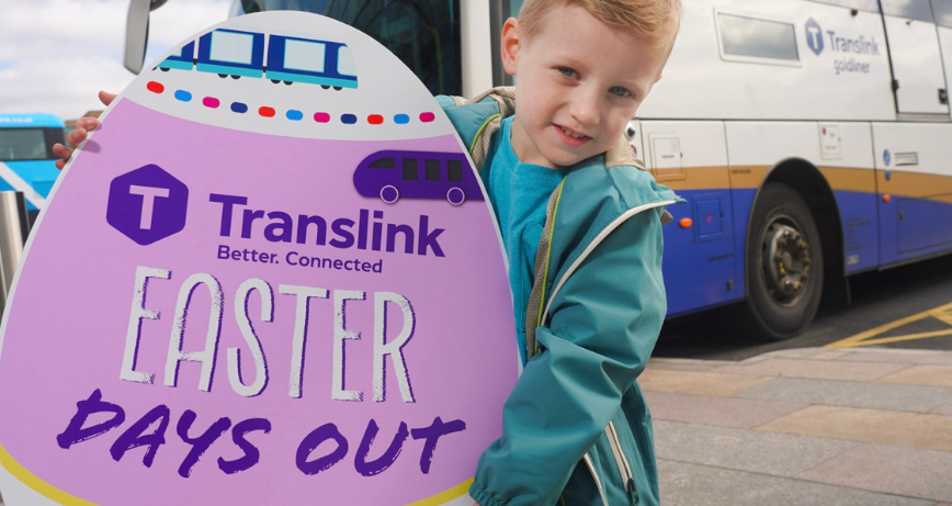 Child holds cardboard egg promoting Translink's Day Out